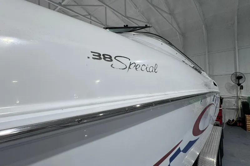 Slide: The Image of 2002 Baja .38 Special boat in a storage facility, showcasing sleek design and branding. - 31