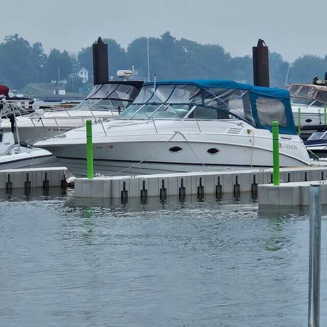 The Image of 1996 Larson Cabrio 280 boat docked in harbor. - 1