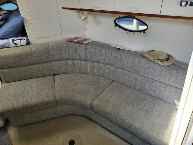 Slide: The Image of Interior of 1996 Larson Cabrio 280 yacht with gray sofa. - 4