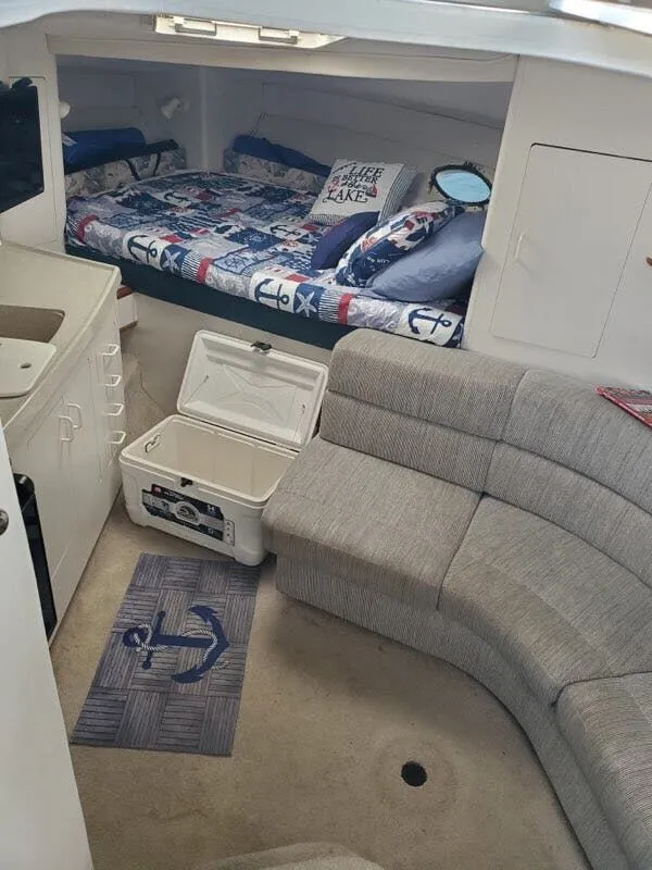 Slide: The Image of Interior of a 1996 Larson Cabrio 280 yacht with bed and sofa. - 5