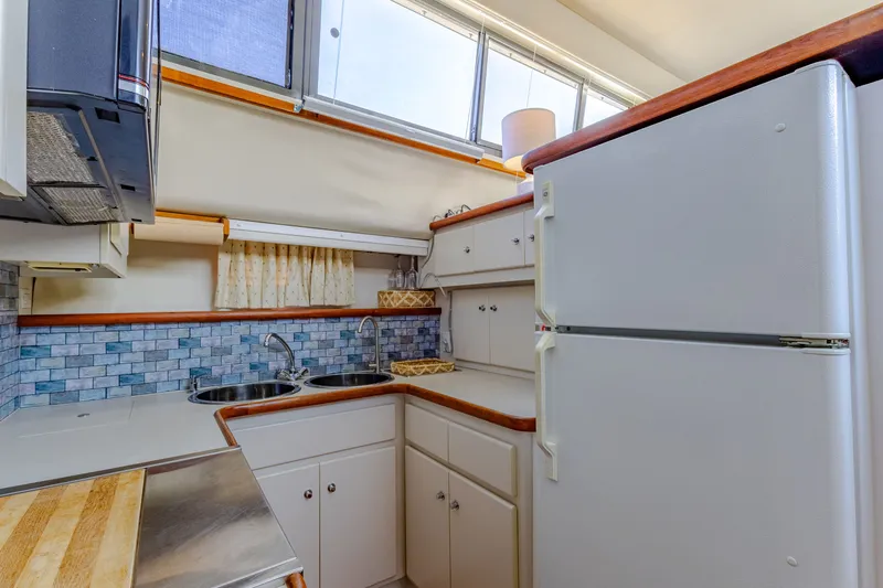 Slide: The Image of 1994 Carver 440 Aft Cabin Yacht kitchen with fridge and sink. - 15