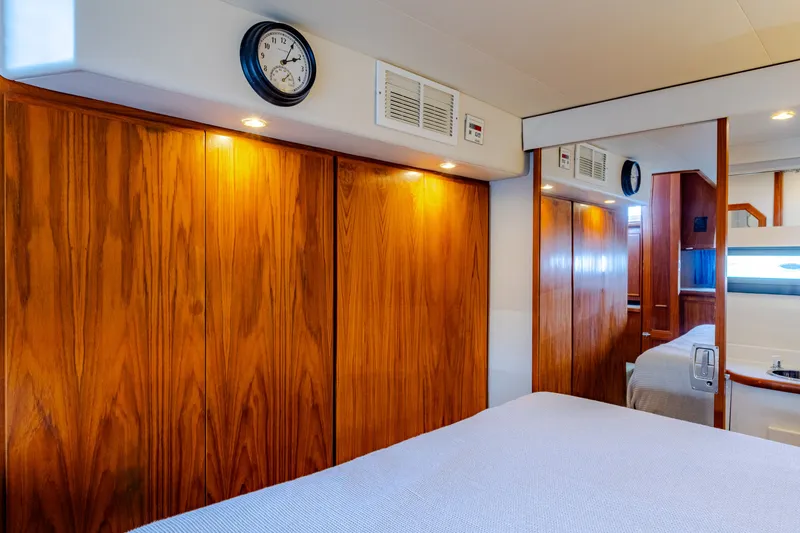 Slide: The Image of Interior of Carver 440 Aft Cabin Yacht, wood paneling and clock. - 18