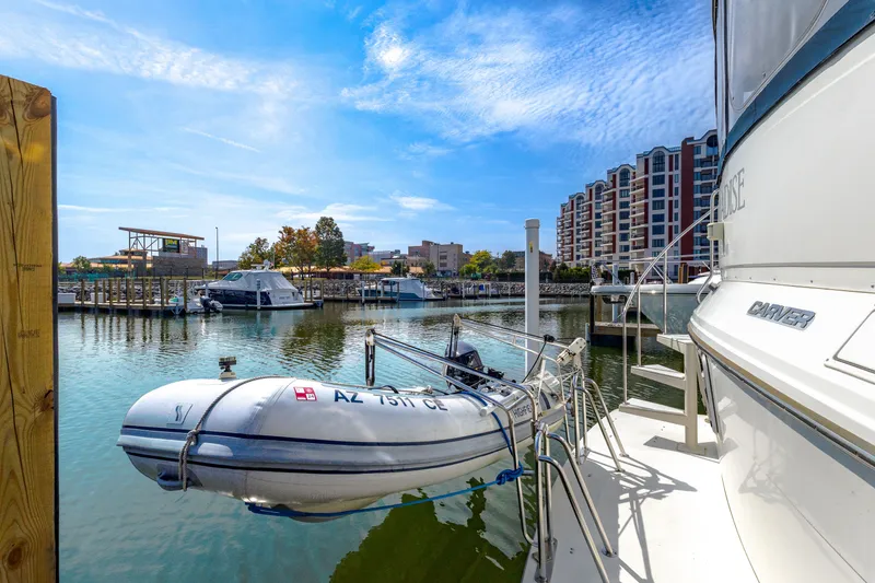 Slide: The Image of 1994 Carver 440 Yacht docked with inflatable boat. - 27