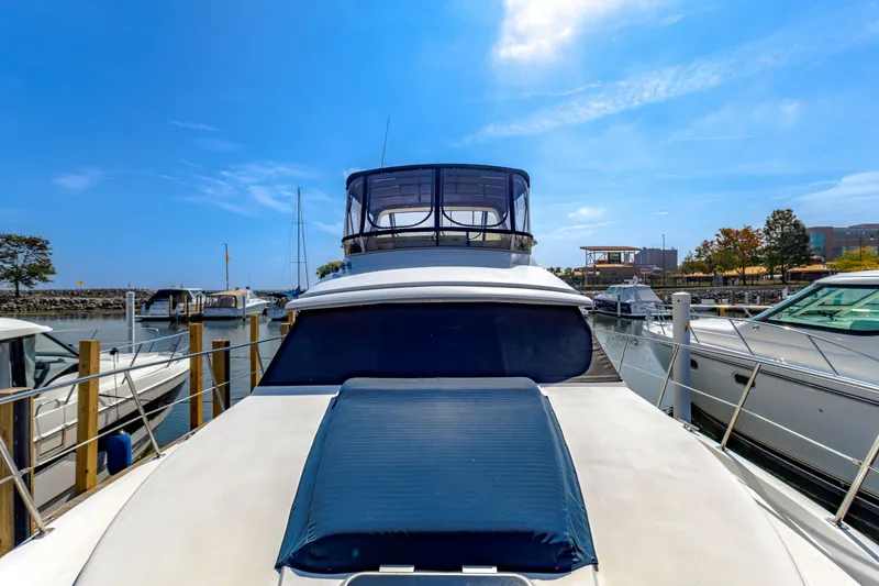 Slide: The Image of 1994 Carver 440 Aft Cabin Motor Yacht docked on a sunny day. - 4