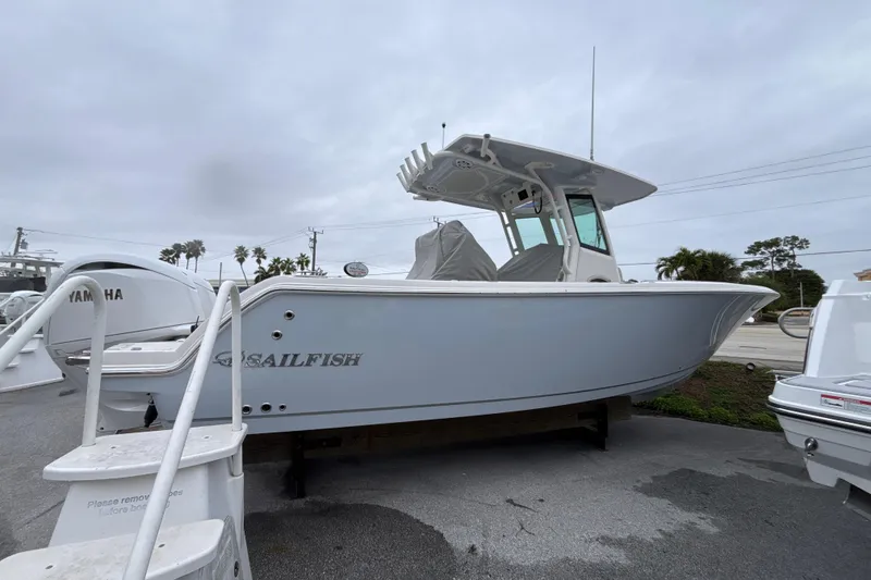 Slide: The Image of 2024 Sailfish 272 CC boat displayed outdoors on a cloudy day. - 1