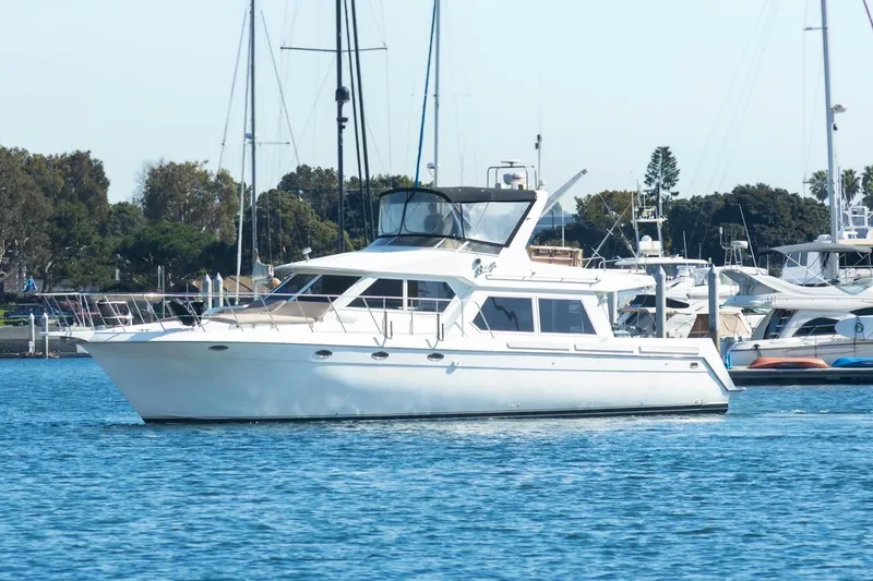 The Image of 1996 Navigator 5300 Classic yacht docked in a marina, surrounded by other boats. - 1