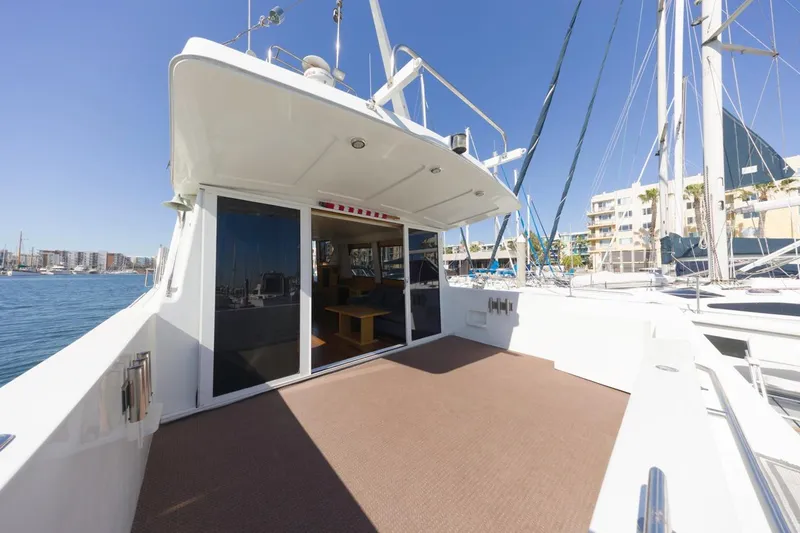 Slide: The Image of 1996 Navigator 5300 Classic yacht with spacious deck, docked in a sunny marina. - 12