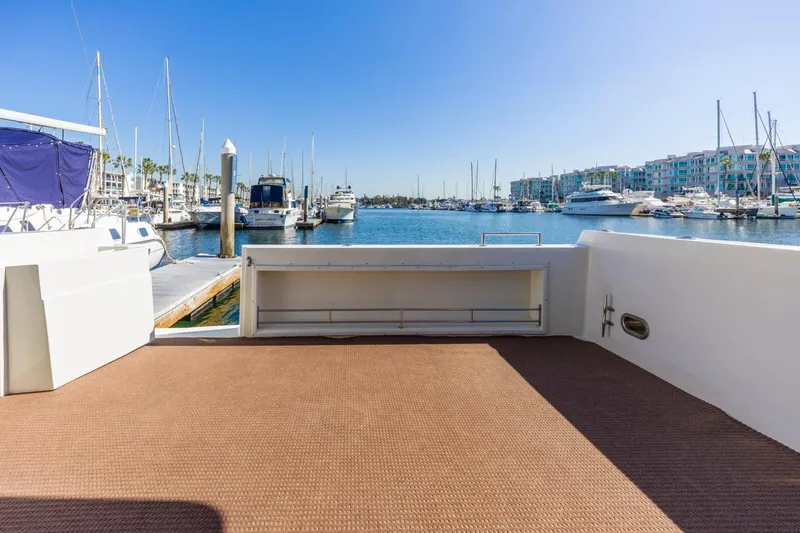 Slide: The Image of 1996 Navigator 5300 Classic yacht deck overlooking marina with boats and clear blue sky. - 14