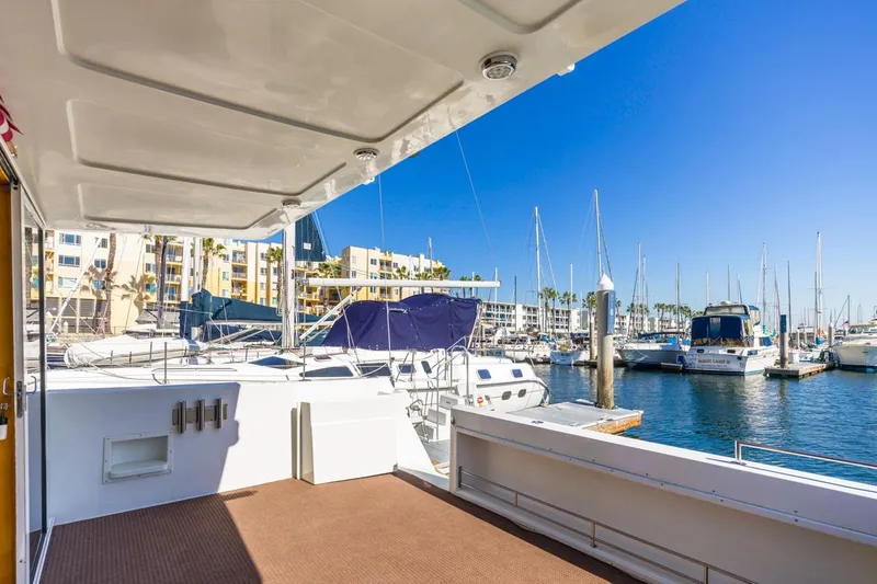 Slide: The Image of 1996 Navigator 5300 Classic yacht docked in a sunny marina with sailboats. - 15