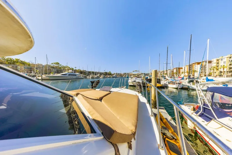 Slide: The Image of 1996 Navigator 5300 Classic yacht docked in a sunny marina, surrounded by sailboats. - 16