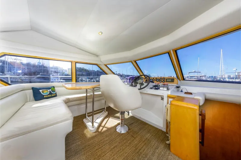 Slide: The Image of Interior of 1996 Navigator 5300 Classic yacht with helm, seating, and marina view. - 43