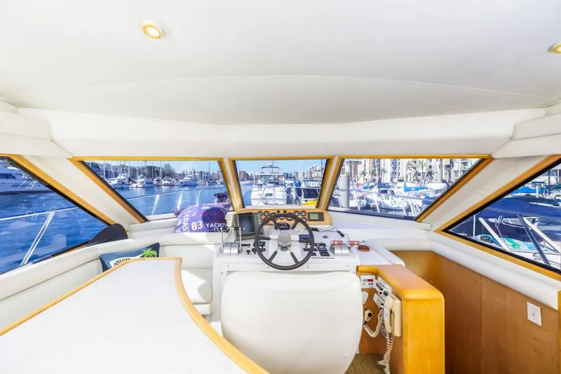 Slide: The Image of Interior view of 1996 Navigator 5300 Classic yacht helm with marina backdrop. - 44