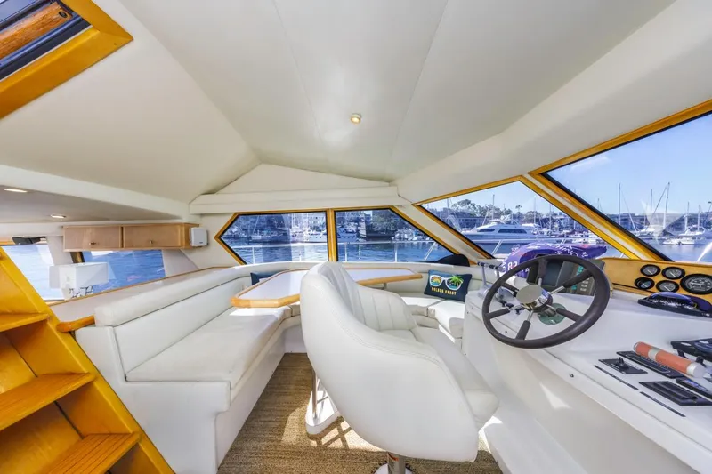 Slide: The Image of Interior of 1996 Navigator 5300 Classic yacht with helm, seating, and marina view. - 47