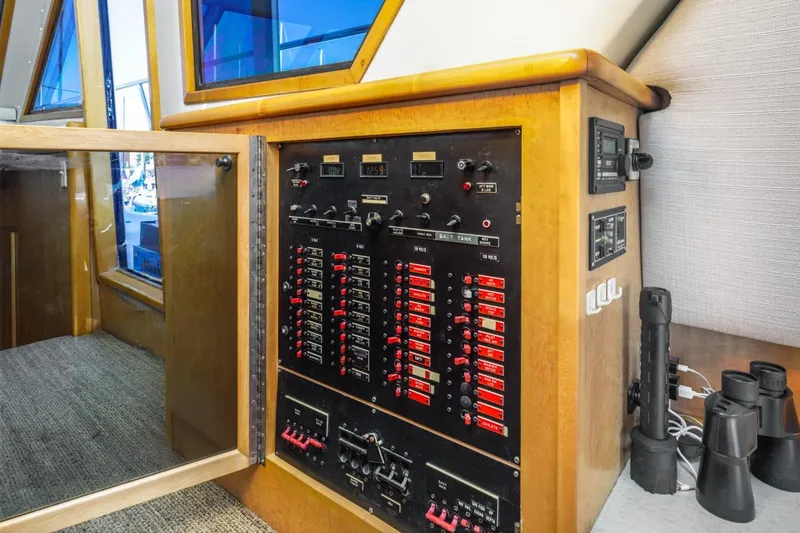 Slide: The Image of Control panel inside 1996 Navigator 5300 Classic yacht, featuring switches and gauges. - 49