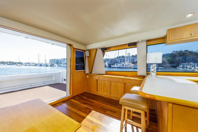 Slide: The Image of Interior of 1996 Navigator 5300 Classic yacht with wooden flooring and marina view. - 51