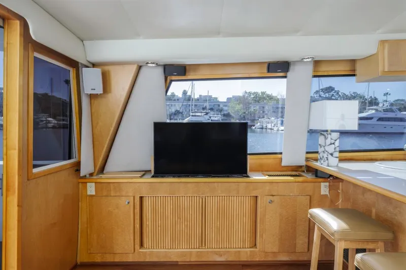 Slide: The Image of Interior of 1996 Navigator 5300 Classic yacht with TV, windows, and wooden cabinetry. - 53
