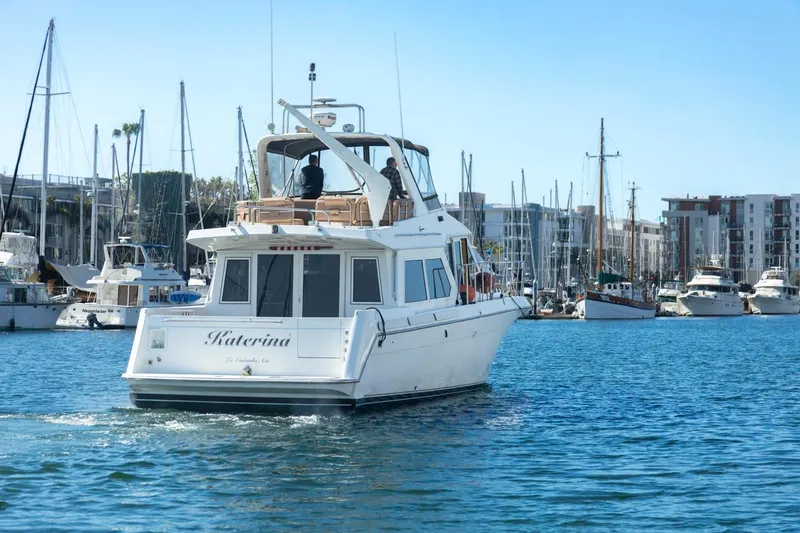 Slide: The Image of Navigator 5300 Classic yacht from 1996 cruising in a marina with sailboats. - 8