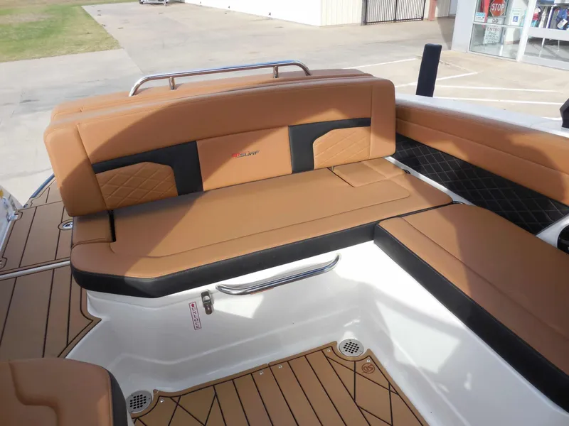 Slide: The Image of The image shows the seating area of a Chaparral GTS 6 boat with brown upholstery. - 29
