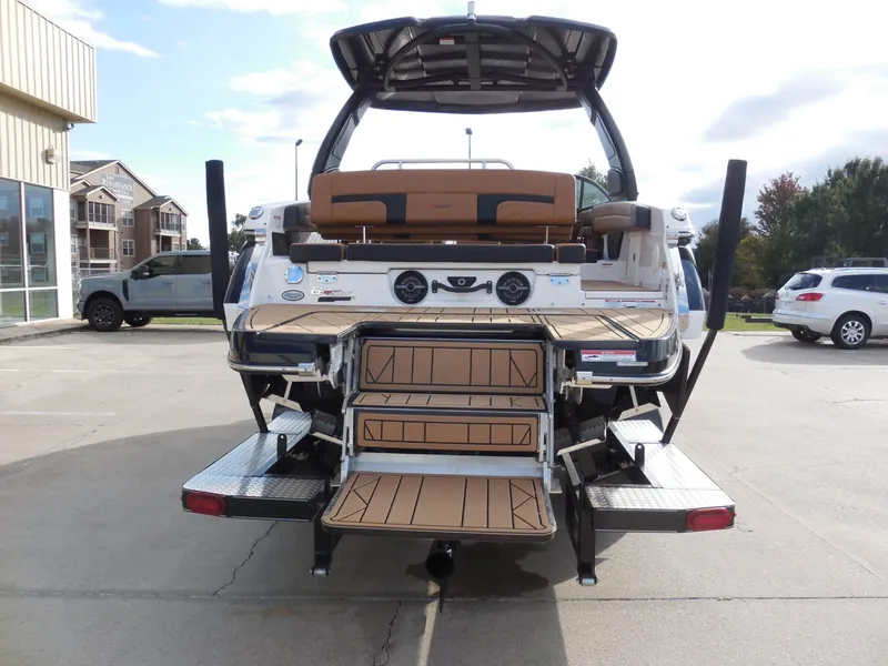 Slide: The Image of The image shows the rear of a 2026 Chaparral GTS 6 boat with a swim platform and steps. - 5