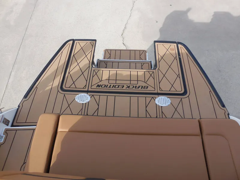 Slide: The Image of Rear view of a 2026 Chaparral GTS 6 with brown decking and "Black Edition" lettering. - 31