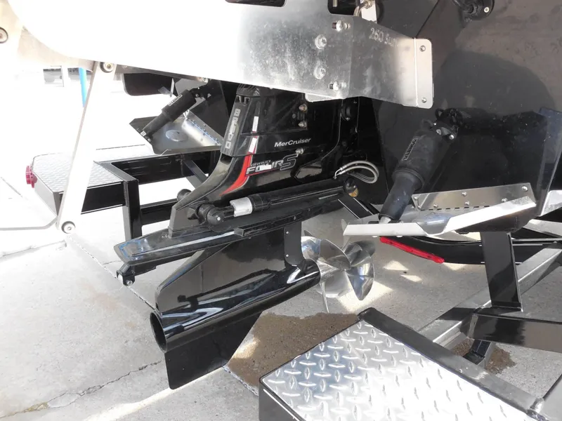 Slide: The Image of Close-up of a boat engine with propeller and metal components. - 13