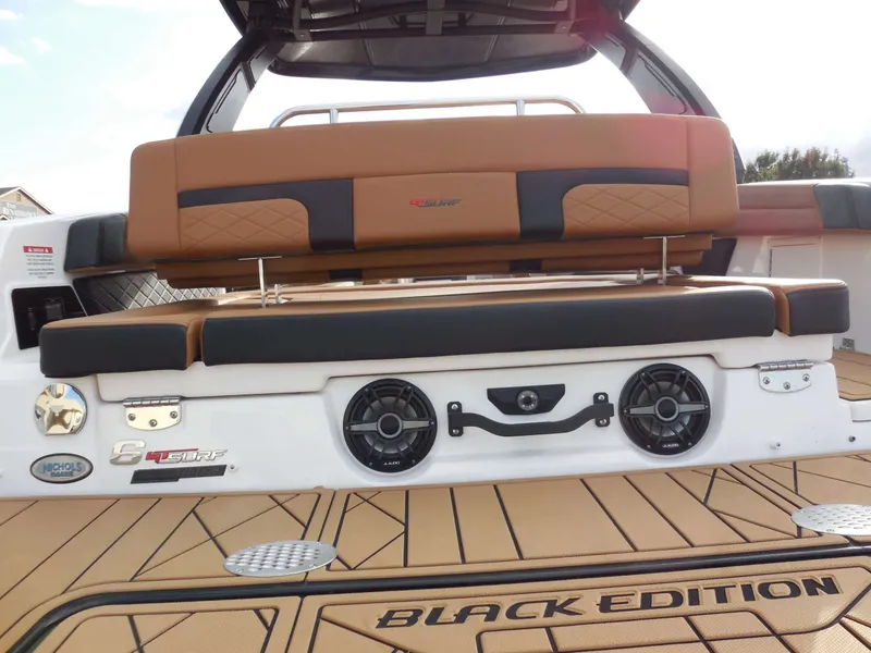 Slide: The Image of The image shows the rear of a Chaparral GTS 6 boat with brown seating and speakers. - 14