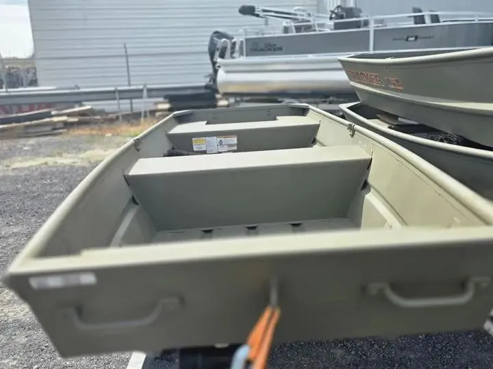 Slide: The Image of 2026 Tracker Grizzly 14 Jon boat on a parking lot. - 6