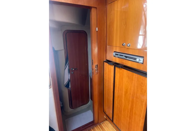 Slide: The Image of 2004 Regal Commodore 3860 yacht interior with wooden cabinetry and door. - 11