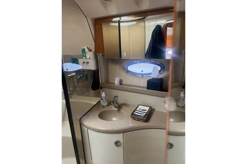 Slide: The Image of Bathroom interior of 2004 Regal Commodore 3860 yacht with sink, mirror, and porthole. - 13