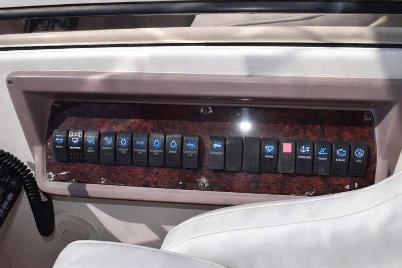 Slide: The Image of Control panel of a 2004 Regal Commodore 3860 boat with labeled switches. - 16