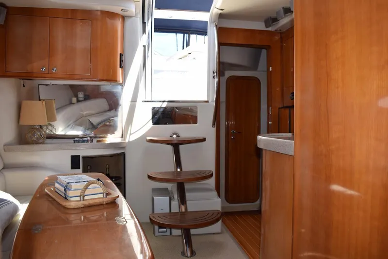 Slide: The Image of Interior of 2004 Regal Commodore 3860 yacht with wooden cabinetry and modern furnishings. - 19