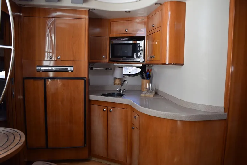 Slide: The Image of Luxurious 2004 Regal Commodore 3860 yacht kitchen with wood cabinetry and modern appliances. - 23