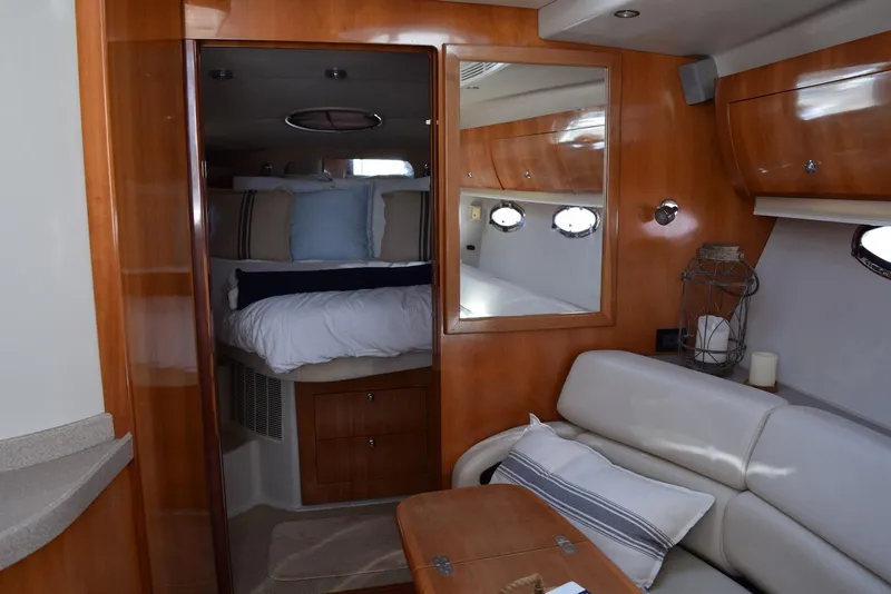 Slide: The Image of Luxurious interior of 2004 Regal Commodore 3860 yacht with cozy seating and elegant wood finish. - 25
