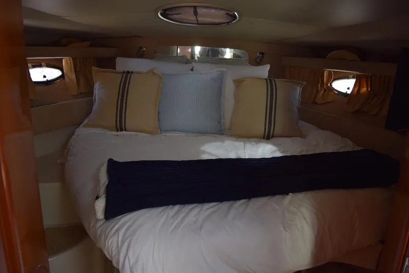 Slide: The Image of Cozy cabin interior of 2004 Regal Commodore 3860 yacht with plush bedding and pillows. - 27