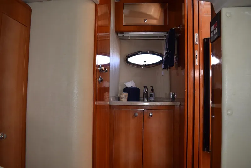 Slide: The Image of 2004 Regal Commodore 3860 yacht interior with wooden cabinetry and compact sink area. - 29