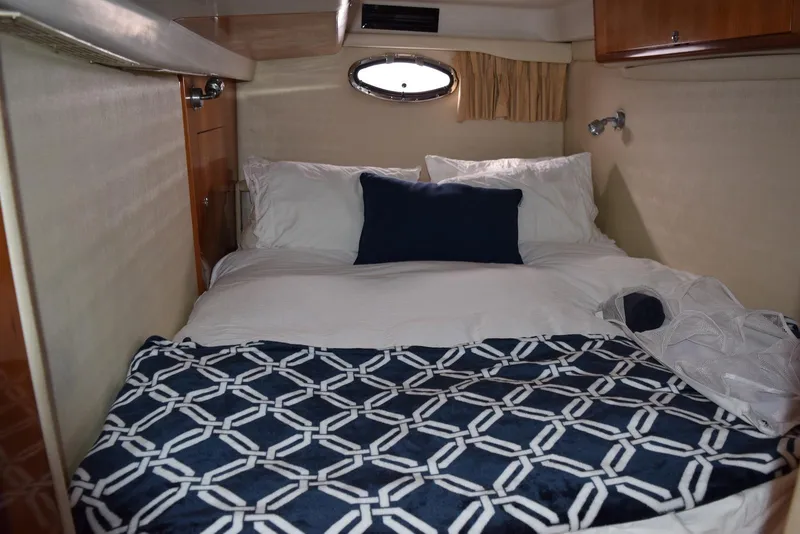 Slide: The Image of Cozy cabin bedroom in 2004 Regal Commodore 3860 yacht with nautical-themed bedding. - 30