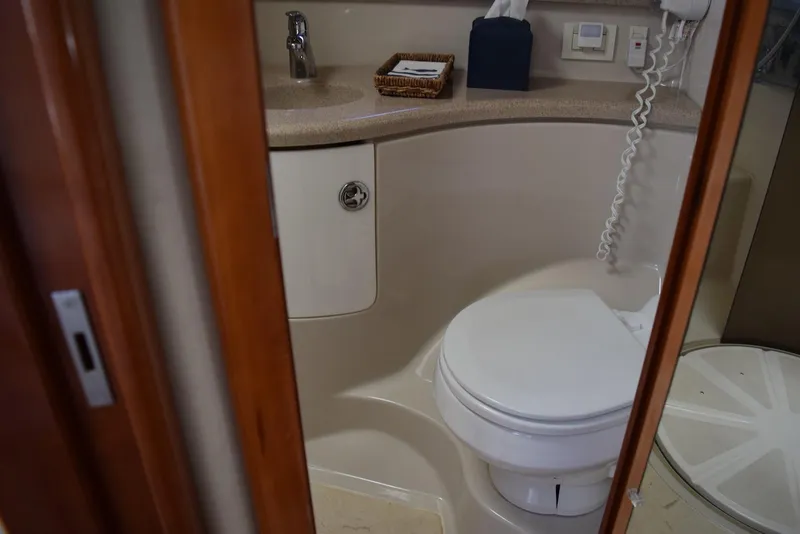 Slide: The Image of Bathroom interior of 2004 Regal Commodore 3860 yacht, featuring toilet and sink. - 32