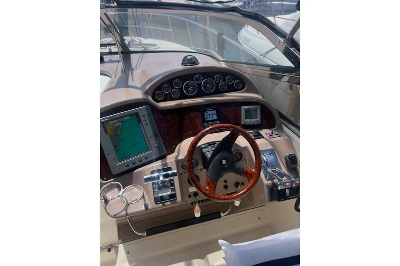 Slide: The Image of 2004 Regal Commodore 3860 yacht dashboard with navigation instruments and wooden steering wheel. - 8