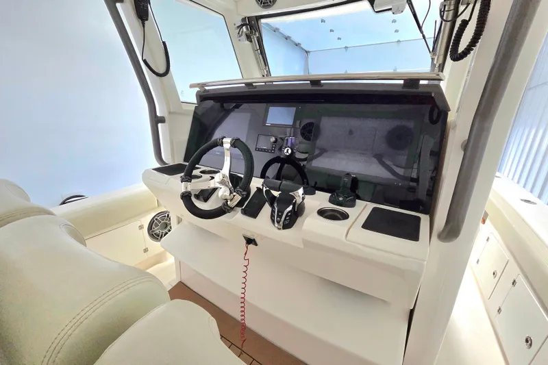 Slide: The Image of 2020 Solace 345 boat helm with modern controls and steering wheel. - 17