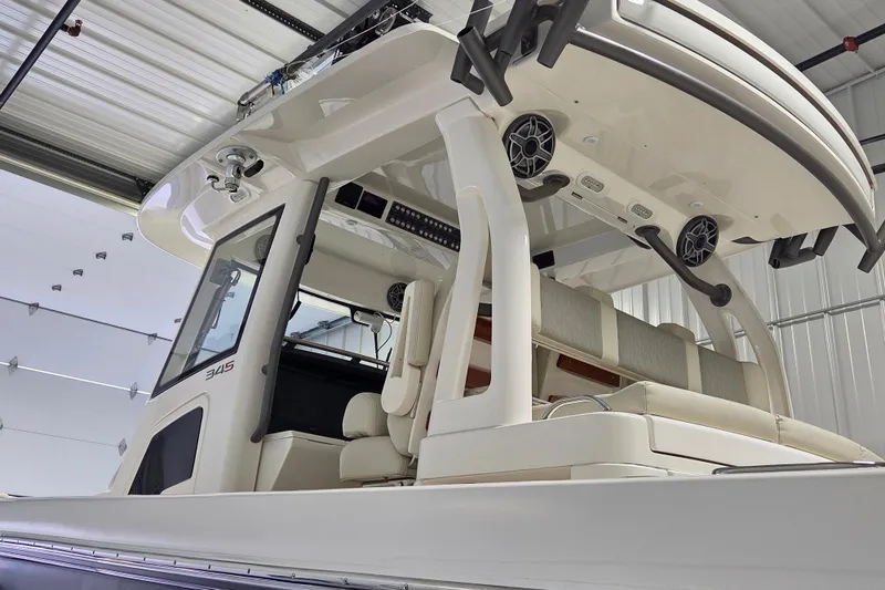 Slide: The Image of 2020 Solace 345 boat interior with seating and speakers in a garage. - 19
