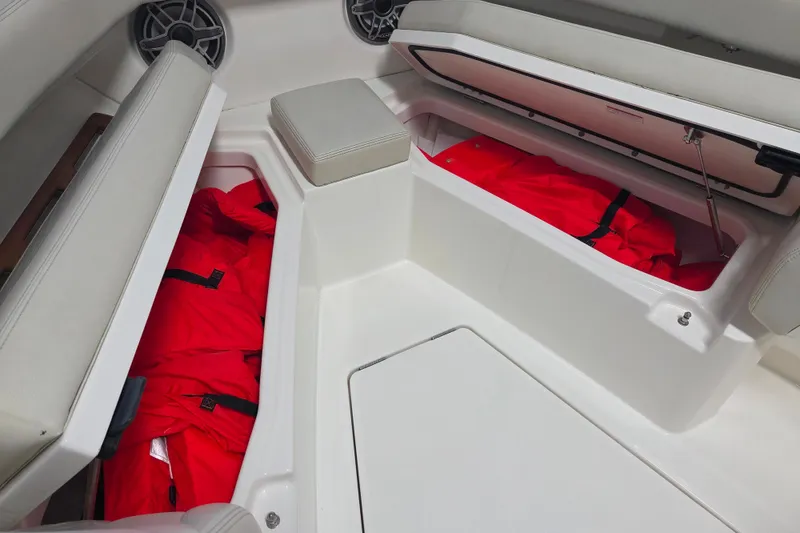 Slide: The Image of 2020 Solace 345 boat storage compartments with red life jackets. - 8