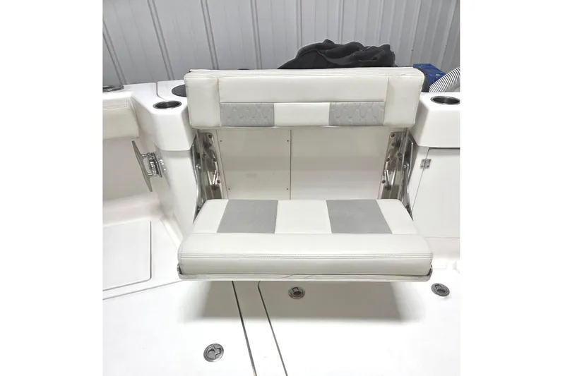 Slide: The Image of Foldable seat on a 2020 Solace 345 boat, featuring white and gray upholstery. - 11