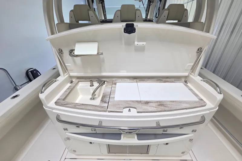 Slide: The Image of 2020 Solace 345 boat interior with sink and cutting board in a sleek design. - 13