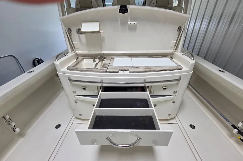 Slide: The Image of 2020 Solace 345 boat interior with open storage drawers and sink area. - 14