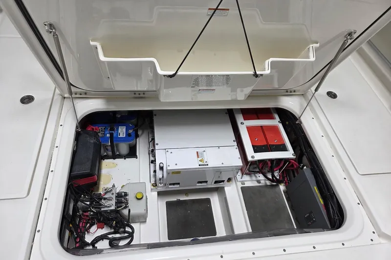 Slide: The Image of 2020 Solace 345 boat electrical compartment with batteries and wiring. - 23