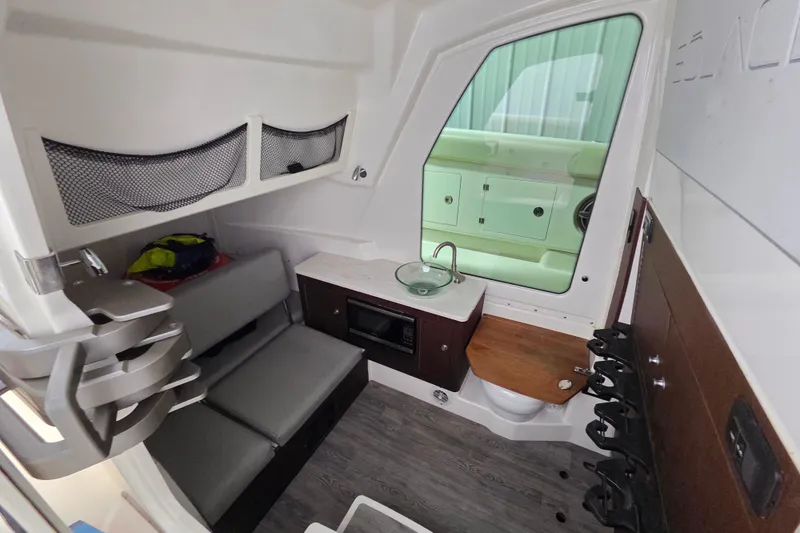 Slide: The Image of Interior of 2020 Solace 345 boat with seating, sink, and storage compartments. - 29