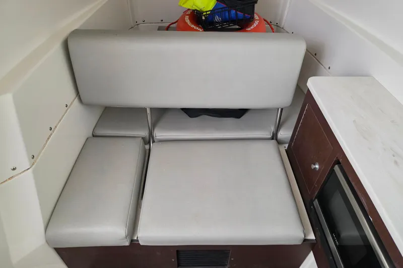 Slide: The Image of Interior of a 2020 Solace 345 boat with cushioned seating and storage. - 30