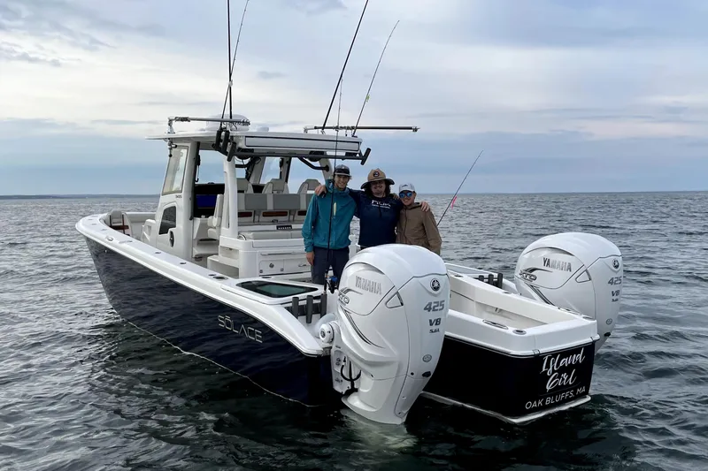 Slide: The Image of Three people on a 2020 Solace 345 boat with Yamaha engines, fishing at sea. - 5