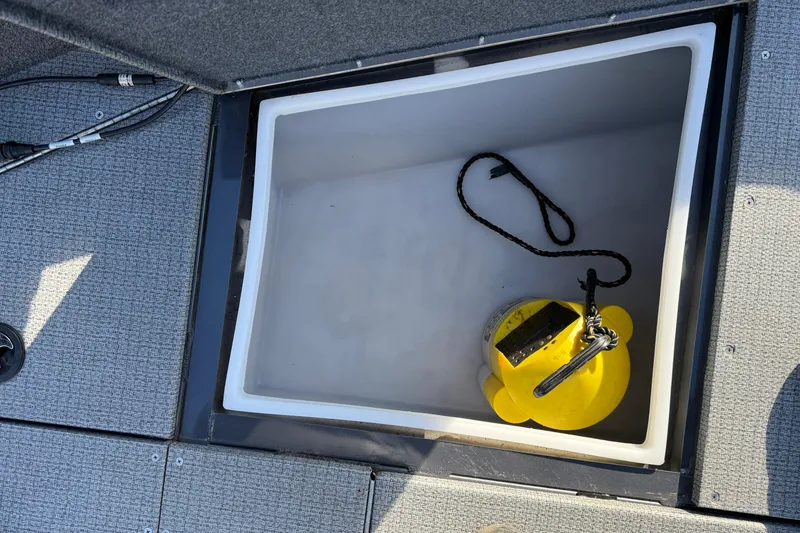 Slide: The Image of Open storage compartment in 2022 G3 Angler V17 T boat with yellow buoy inside. - 13