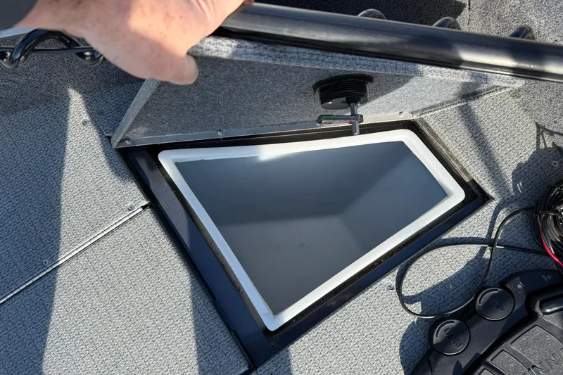 Slide: The Image of 2022 G3 Angler V17 T boat storage compartment with open lid and visible wiring. - 15